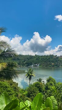 Mountain with lake, blue sky and clouds. Lake Sebu. Mindanao, Philippines. Vertical view.
