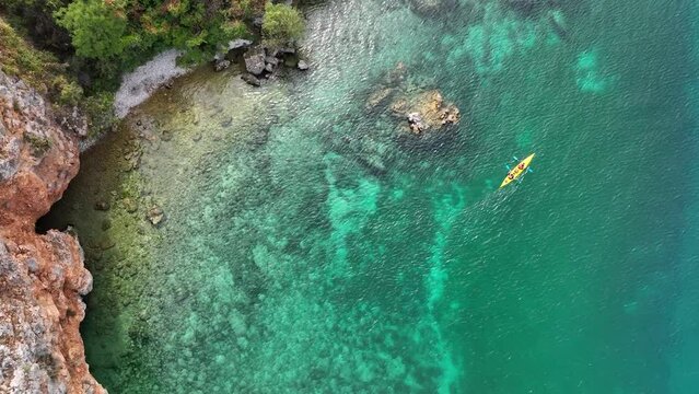 Aerial Top view on Kayak in the Lake Ohrid in North Macedonia, the deepest and oldest lake in the Balkans with turquoise