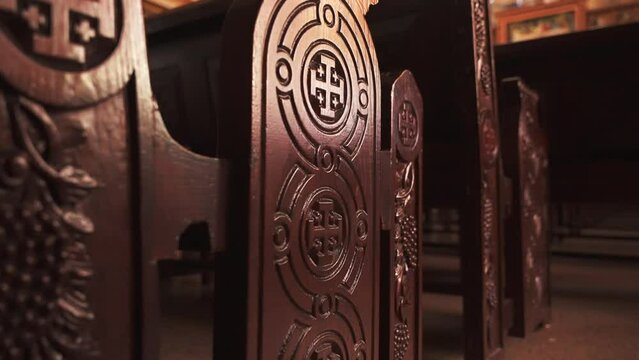 Close-up of wooden bench with carvings cross on the side in The Coptic Orthodox Church 