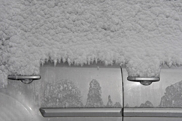 Snow at night covers windows of 4 door car and freezes locks 