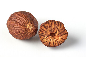 Two nutmegs isolated on a white background. Aromatic spice for cooking