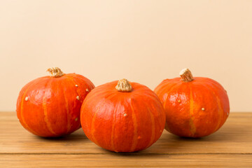 Orange pumpkins with autumn decor on wooden table