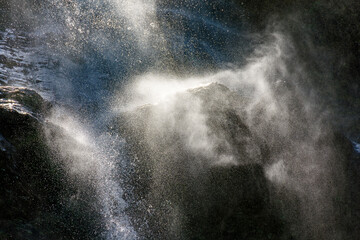 Water splashing against rocks and mist in the air at a waterfall in the state of Minas Gerais, Brazil