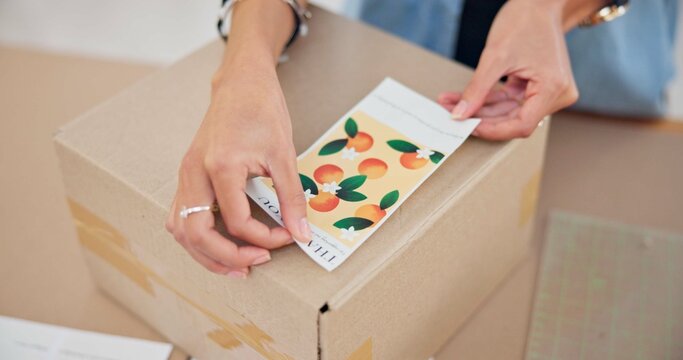 Online order, label sticker and woman hand with small business in fashion with delivery and cardboard box. Stock, startup and sales of ecommerce and boutique at home of a entrepreneur with package