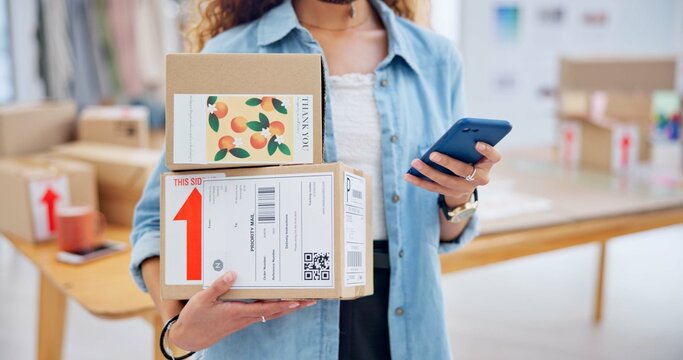 Package, startup and closeup of woman with phone for business at a fashion retail boutique. Networking, technology and female entrepreneur with cardboard boxes and cellphone for delivery information. - Powered by Adobe