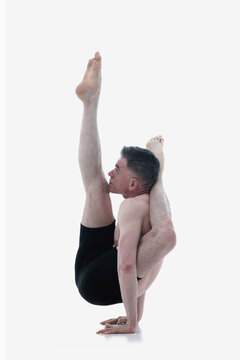 Eka pada sirsasana (shirshasana), Ashtanga yoga  Side view of man wearing sportswear doing Yoga exercise against white background.