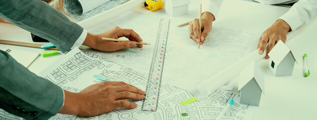 Worker, architect and engineer work on real estate construction project oratory planning with...
