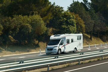 A motorhome is moving along the highway.