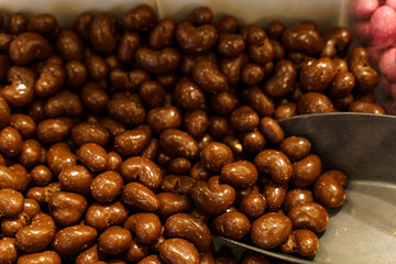 There are candies on the counter - chocolate covered peanuts and a scoop.