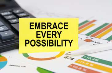 On business reports there is a calculator and a sign with the inscription - Embrace Every...