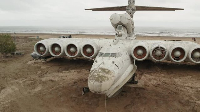 Derbent, Dagestan, December 07, 2022: Aerial view of a military aircraft ekranoplan Lun on the seashore of the Caspian Sea. Soviet military aircraft. Detailed shooting.
