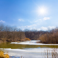 frozen river covered by snow at sunny day, winter seasonal outdoor landscape