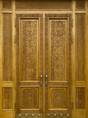 Wooden carved door with detailed decorative geometric designs