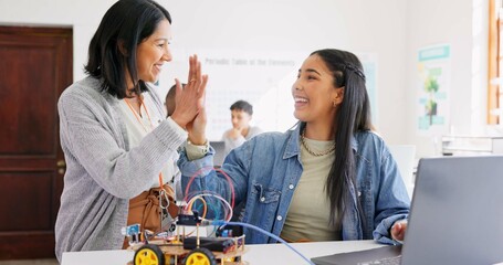 Learning, teacher and high five of student on laptop in classroom, achievement or goal in robotics....