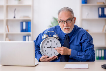 Old male employee in time management concept