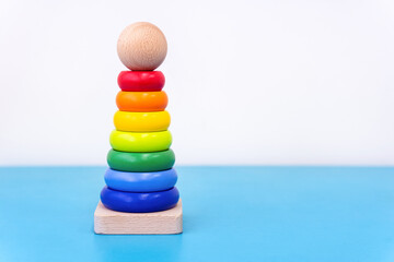 Rainbow donut stacking tower toy for toddlers on a white background