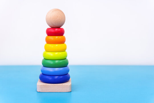 Rainbow donut stacking tower toy for toddlers on a white background