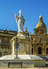 Statue of St. Nicholas in front of the Parish Church of San Nicholas, Siggiewi, Malta. Vertical.