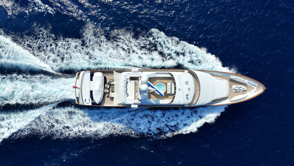 Aerial drone photo of latest technology yacht cruising near famous beach of Super paradise, Mykonos...