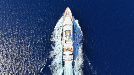 Aerial drone photo of latest technology yacht cruising near famous beach of Super paradise, Mykonos...