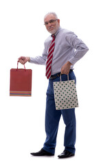 Old businessman holding bags isolated on white