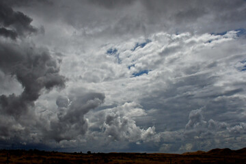 Fototapeta na wymiar Cloudscape . Multilevel clouds from cumulus to Altostratus, Sierra Nevada Mountains 