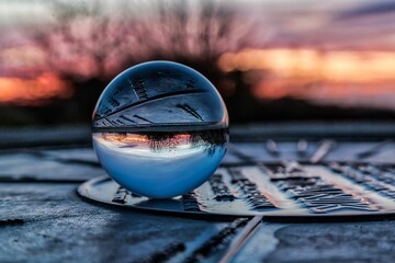 Spherical object illuminated by the sun in the background