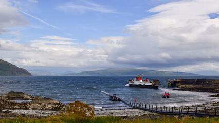 Ferry boat leaving small port while retracting roro ramp