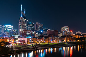 Scenic View of Broadway district of Nashville over Cumberland River at illuminated night skyline,...
