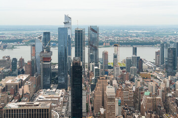 Fototapeta na wymiar Aerial panoramic city view of West Side Manhattan and Hudson Yards district at day time, NYC, USA. New Jersey on horizon over the Hudson River. A vibrant business neighborhoods.