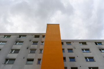 An apartment building with an orange elevator shaft
