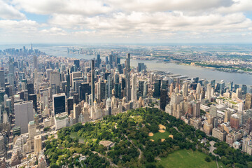 Aerial panoramic city view of Midtown Manhattan neighborhoods towards lower Manhattan and Downtown, Central Park on bottom, New York City. Bird's eye view from helicopter of metropolis cityscape