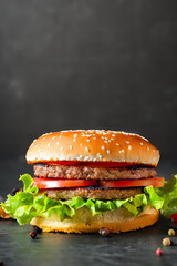 Burger. Juicy burger. Food. Street food. Fast food. Junk food. Cutlet. Burger on black background
