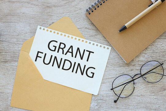 Grant funding text on a page in an envelope on a work desk