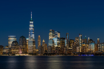 Fototapeta na wymiar Skyline of New York City Financial Downtown Skyscrapers at night. Manhattan, NYC, USA. A vibrant business neighborhood