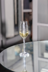 Forgotten glass with unfinished champagne on a glass table