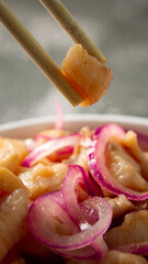 fish ceviche with onions and pepper. traditional peruvian food with tigra milk