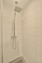 a bathroom with white tiles on the wall and shower head mounted to the wall in front of the bathtub