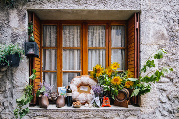 Fototapeta na wymiar Window heavily decorated in the medieval village of Chatillon en Diois in the south of France (Drome)