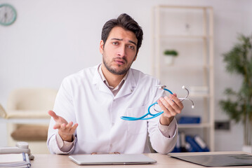 Young male doctor working in the clinic