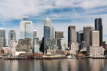 Fototapeta na wymiar Waterfront Seattle skyline with Great wheel view. Skyscrapers of financial downtown at day time, Washington, USA. A vibrant business neighborhood