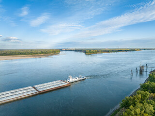 towboat with barges on the Mississippi River at confluence with the Missouri River below Alton, IL
