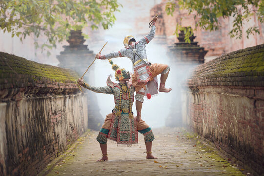 Two traditional khon dancers performing outside a temple, Thailand