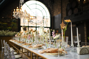beautiful elegant decor of flowers and elegant serving on the wedding table. Modern wedding decoration