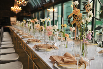 beautiful elegant decor of flowers and elegant serving on the wedding table. Modern wedding decoration