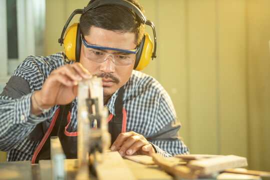Portrait of a carpenter working in a workshop, Thailand