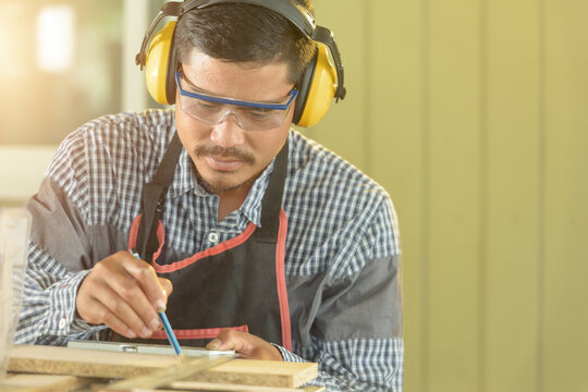 Portrait of a carpenter working in a workshop, Thailand