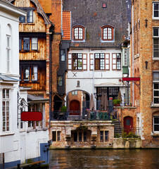 Bruges, Belgium. Ancient medieval architecture. Old stone and wooden houses above water channels in Brugge. Historic town, famous european landmark