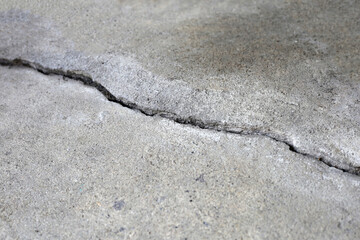 Fototapeta na wymiar Home building problem. Cracked concrete floor, broken building structure