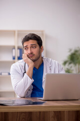 Young male doctor working in the clinic